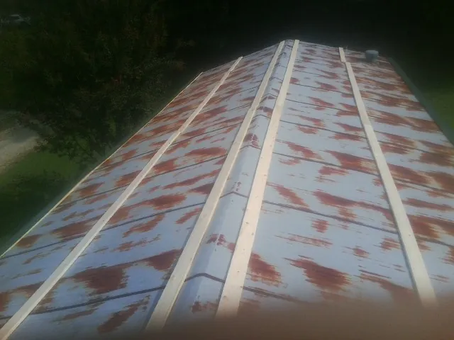 Rusted metal roof panels with new wood purlins before replacement — Storm Damage Roof Repair in Grays River by Roofing Brothers